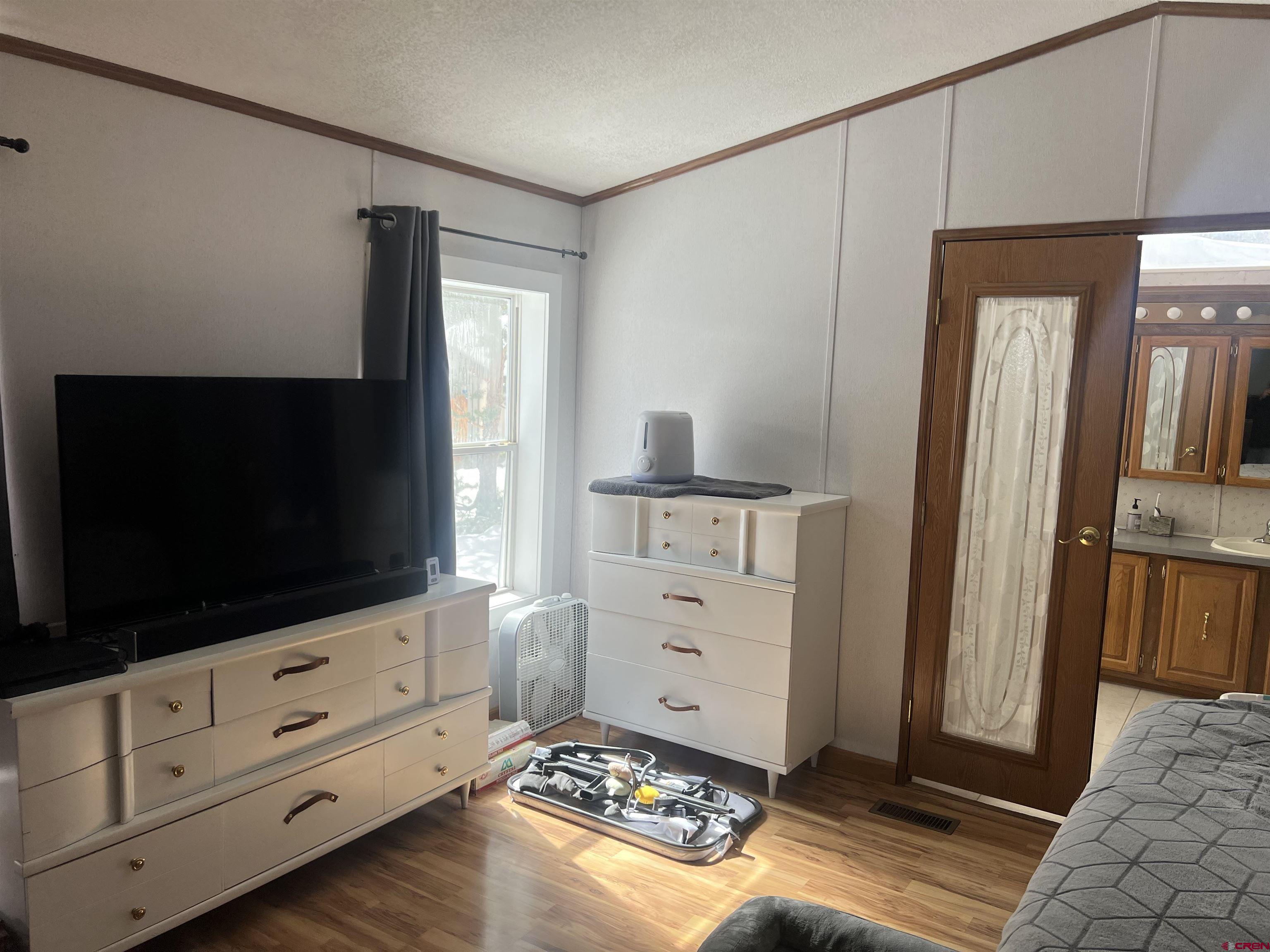 512 Red Lady Avenue Crested Butte, CO 81224 - Photo 2 of 2 a living room with flat screen tv and a dresser