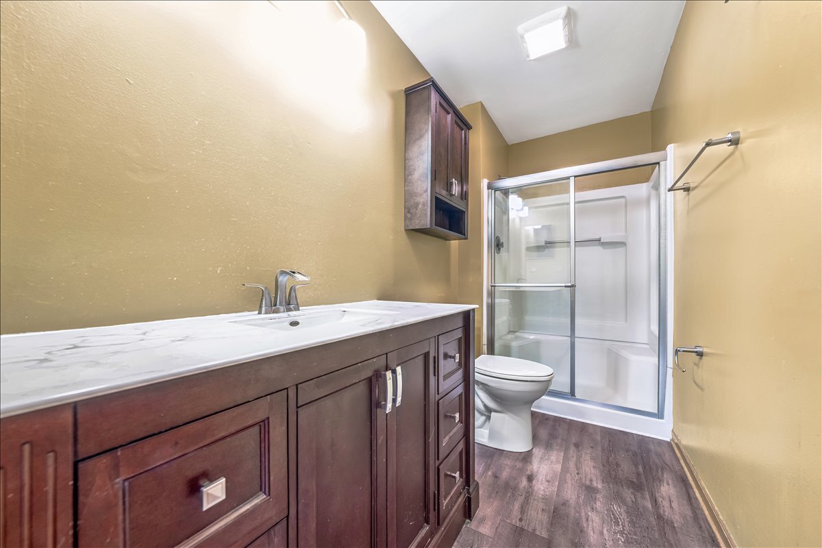 3 Taylor Court, Unit B Streamwood, IL 60107 - Photo 17 of 30 a bathroom with a granite countertop sink toilet and shower