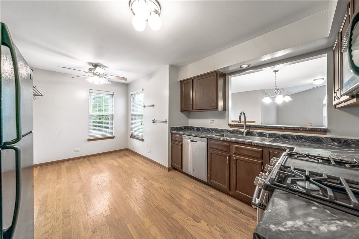3 Taylor Court, Unit B Streamwood, IL 60107 - Photo 2 of 30 a kitchen with a stove a sink and a refrigerator