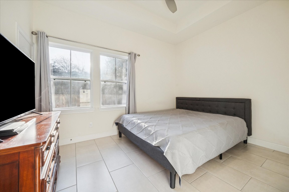 532 Carrell Street Tomball, TX 77375 - Photo 18 of 28 A secondary bedroom filled with abundant natural light, promoting energy efficiency and offering generous space for comfortable furniture placement.