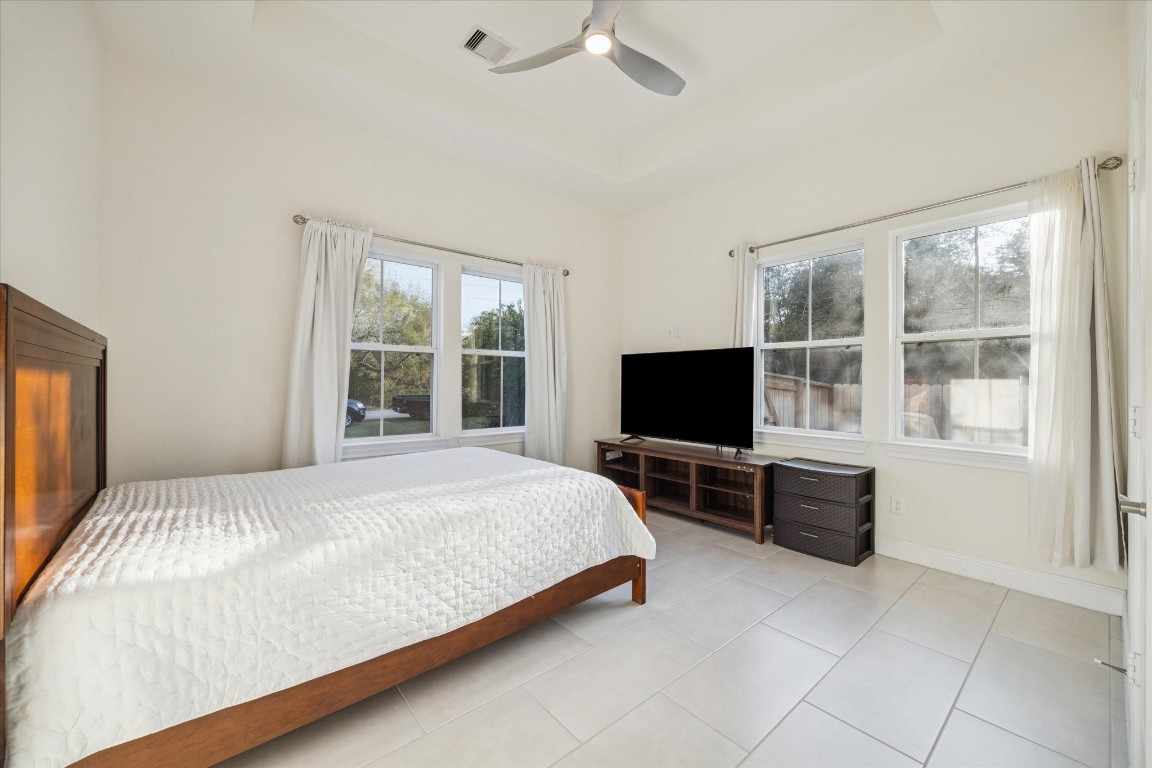 532 Carrell Street Tomball, TX 77375 - Photo 20 of 28 This image highlights one of the secondary bedrooms, featuring generous space, abundant natural light, and elegant ceiling fascia details.