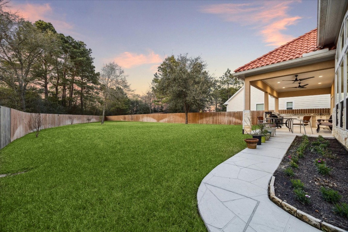 532 Carrell Street Tomball, TX 77375 - Photo 25 of 28 This beautiful rear view highlights the quality construction details, elegance, and spacious design that make this home truly unique and ready for family enjoyment. The image also showcases the covered patio and the location of the outdoor kitchen, ideal for outdoor living and entertaining.