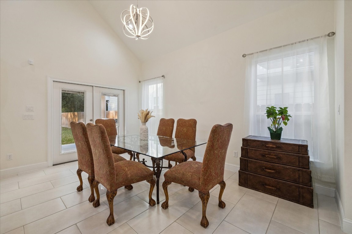 532 Carrell Street Tomball, TX 77375 - Photo 9 of 28 The dining area is highlighted in this image, offering high ceilings, beautiful flooring, and abundant natural light. The warm and inviting atmosphere creates an ideal setting for everyday meals and special gatherings.