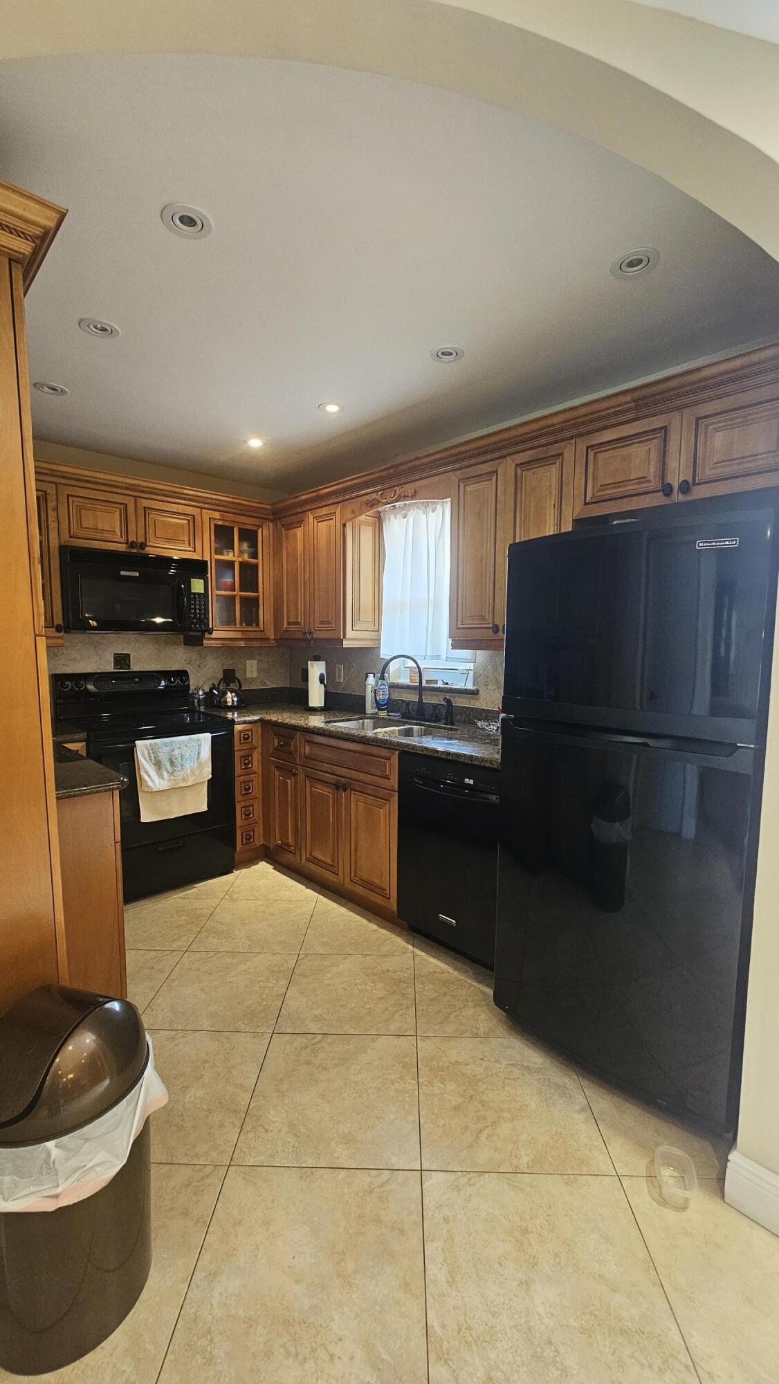 504 Davis Road, Unit 96 Palm Springs, FL 33461 - Photo 17 of 42 a kitchen with a refrigerator and a stove top oven