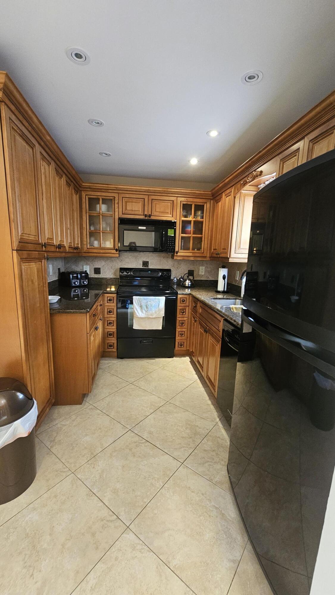 504 Davis Road, Unit 96 Palm Springs, FL 33461 - Photo 18 of 42 a kitchen with a sink appliances and cabinets