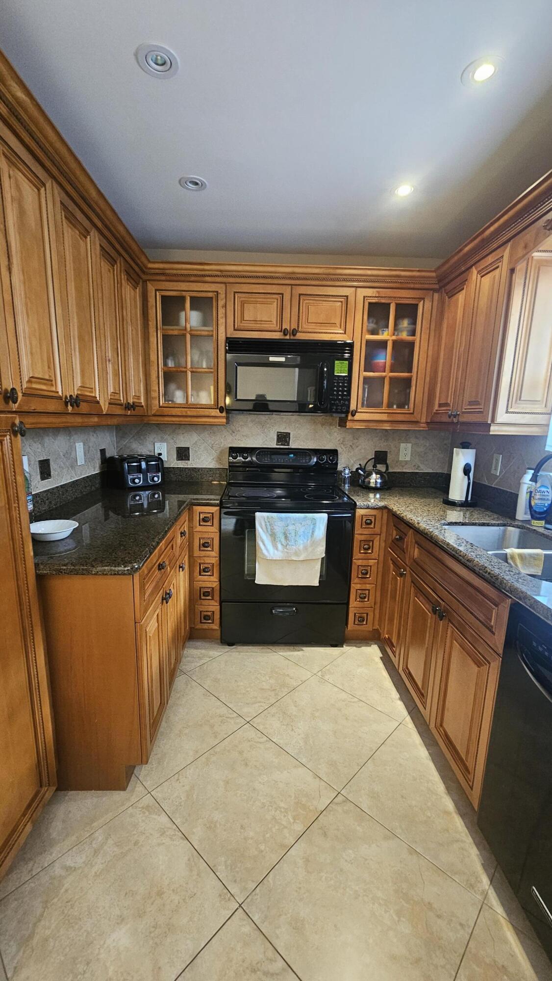 504 Davis Road, Unit 96 Palm Springs, FL 33461 - Photo 19 of 42 a kitchen with stainless steel appliances granite countertop a stove a sink dishwasher and a refrigerator