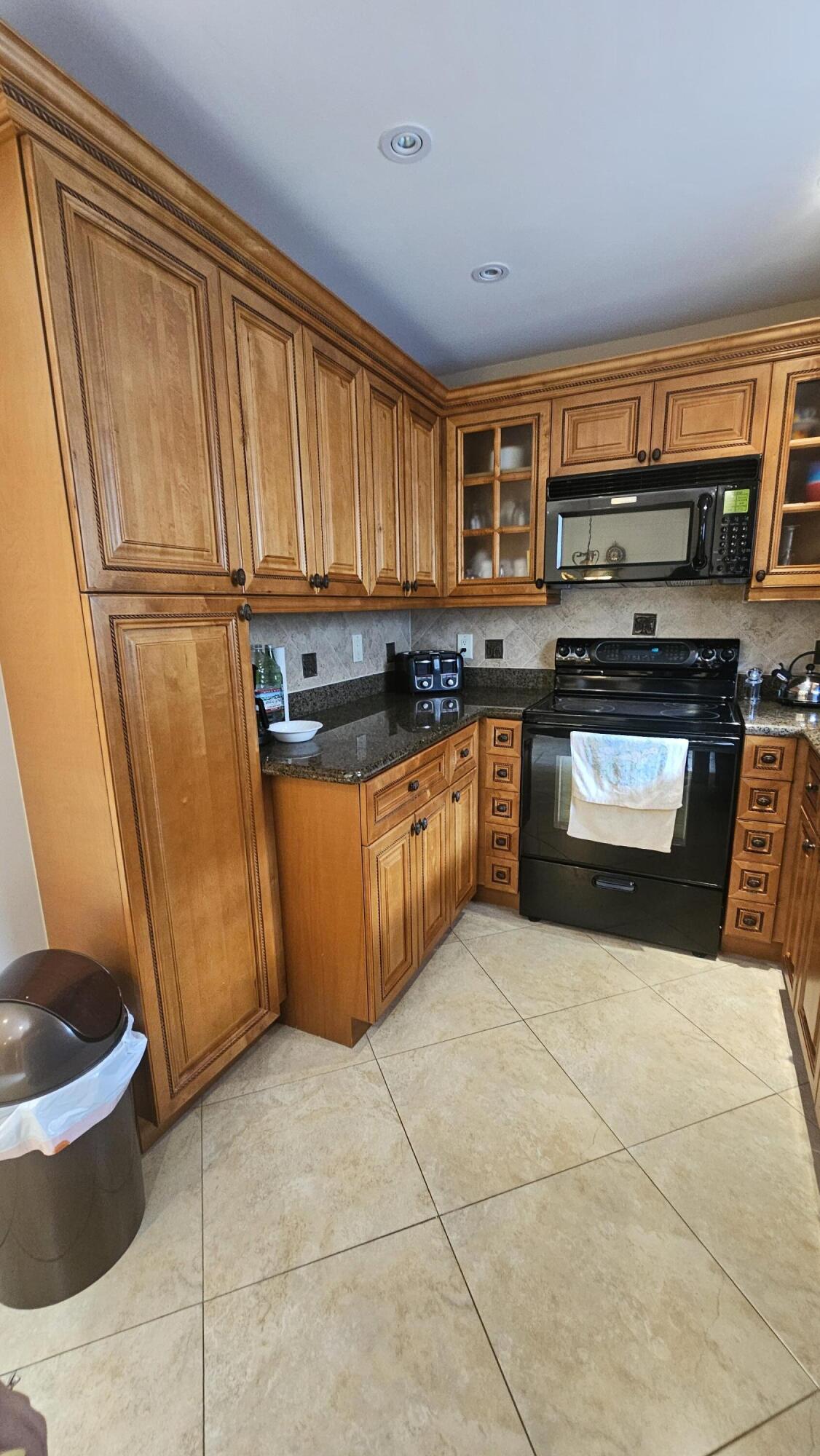 504 Davis Road, Unit 96 Palm Springs, FL 33461 - Photo 20 of 42 a kitchen with stainless steel appliances granite countertop a stove a sink and a microwave