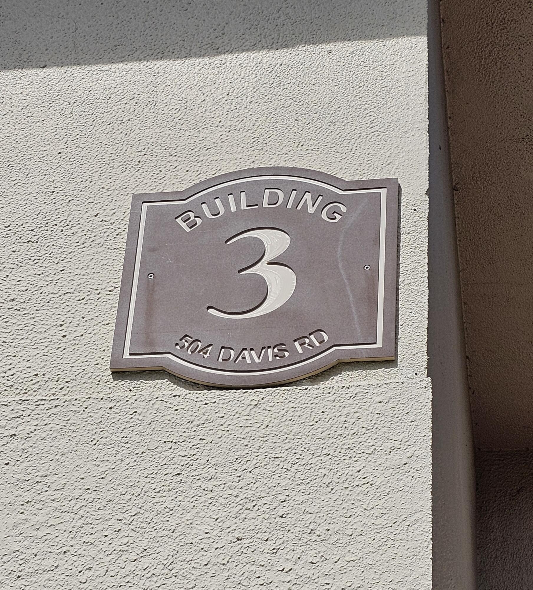 504 Davis Road, Unit 96 Palm Springs, FL 33461 - Photo 2 of 42 a sign that is on the wall