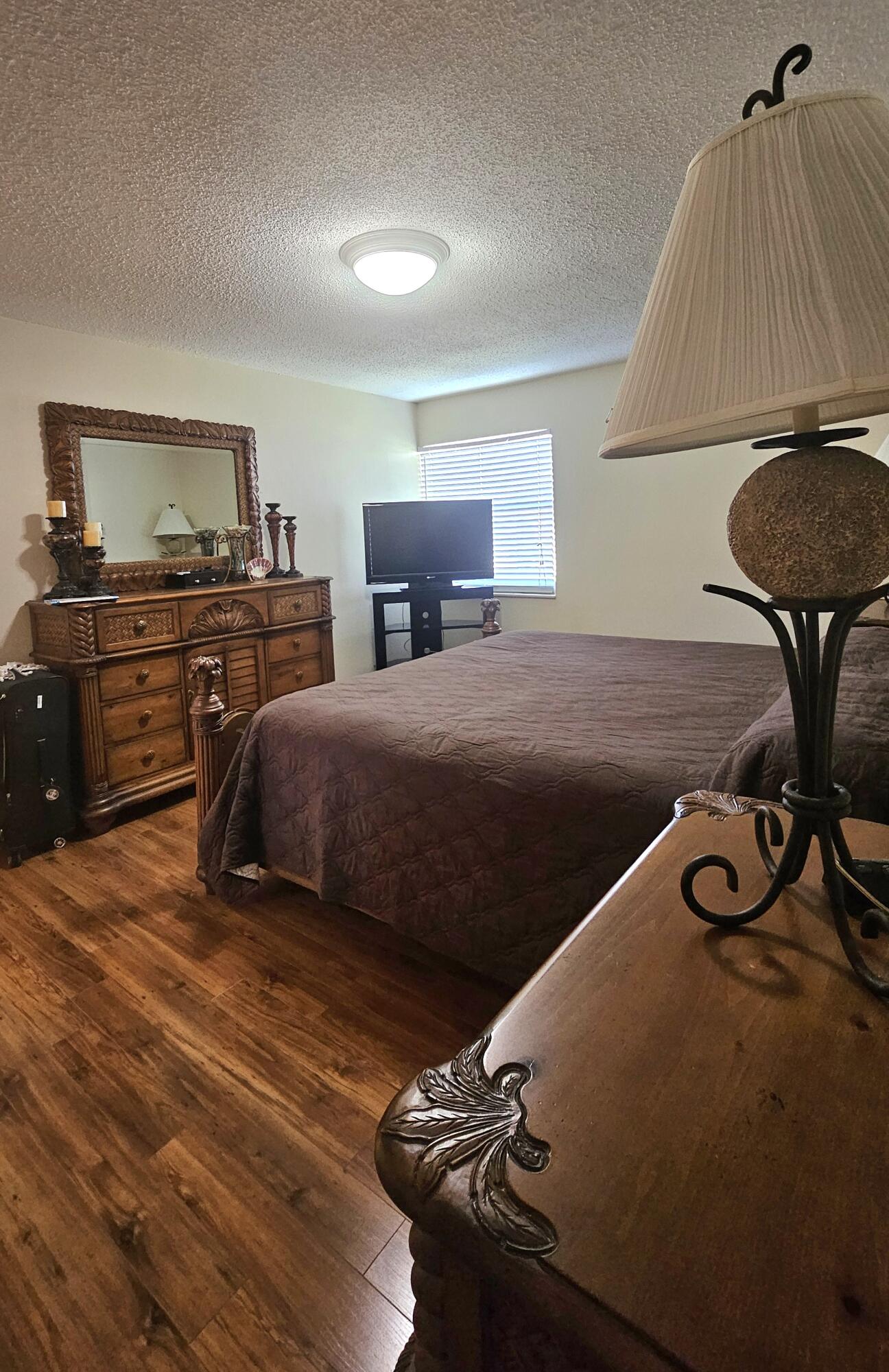 504 Davis Road, Unit 96 Palm Springs, FL 33461 - Photo 23 of 42 a bedroom with a bed and a chair