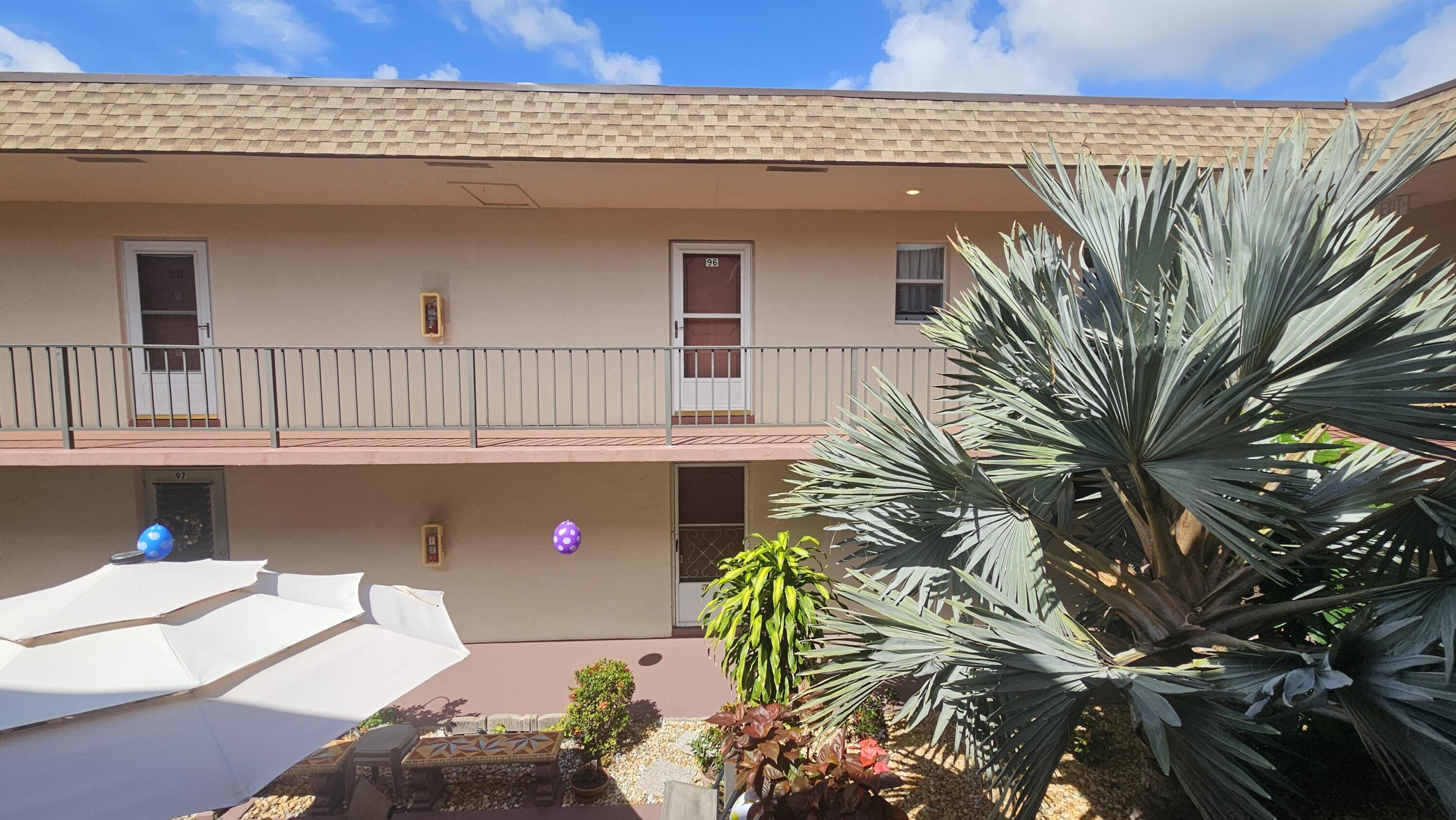 504 Davis Road, Unit 96 Palm Springs, FL 33461 - Photo 7 of 42 a front view of a house with balcony