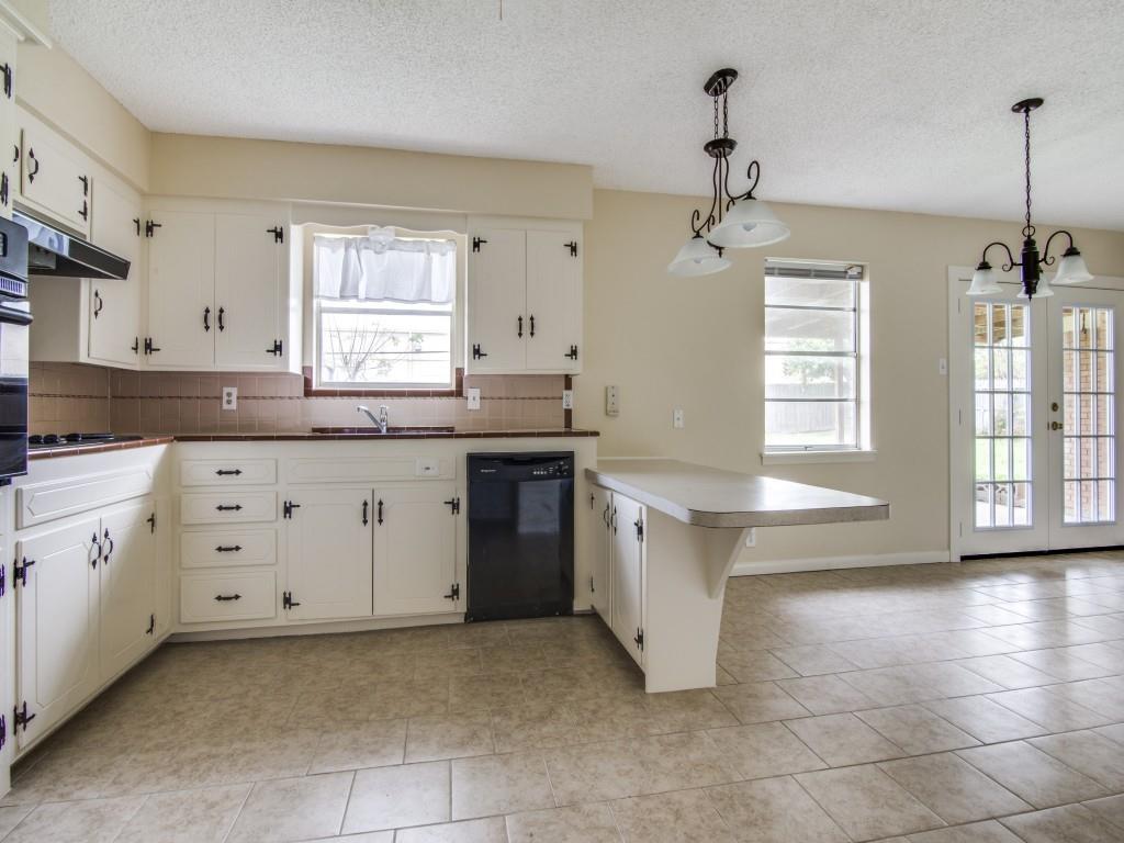 420 Vicki Place Hurst, TX 76053 - Photo 6 of 12 a kitchen with granite countertop a sink a stove a oven and a window