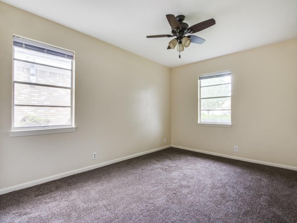 420 Vicki Place Hurst, TX 76053 - Photo 7 of 12 an empty room with a window and a ceiling fan