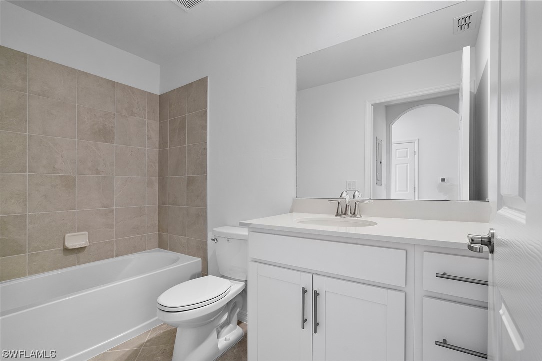 43989 Boardwalk Loop, Unit 2033 Punta Gorda, FL 33982 - Photo 11 of 36 a bathroom with a sink toilet vanity and tub