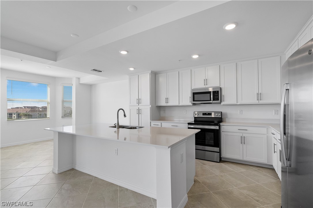 43989 Boardwalk Loop, Unit 2033 Punta Gorda, FL 33982 - Photo 22 of 36 a kitchen with stainless steel appliances granite countertop a sink stove and refrigerator