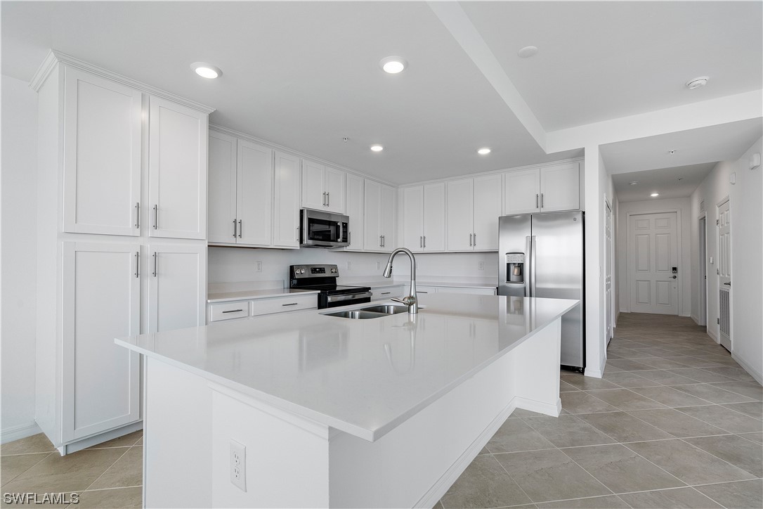 43989 Boardwalk Loop, Unit 2033 Punta Gorda, FL 33982 - Photo 23 of 36 a kitchen with stainless steel appliances a refrigerator sink and stove