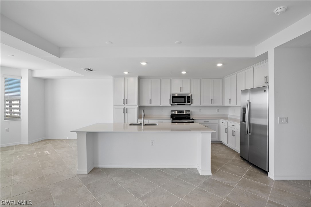43989 Boardwalk Loop, Unit 2033 Punta Gorda, FL 33982 - Photo 29 of 36 a kitchen with stainless steel appliances a refrigerator sink and stove