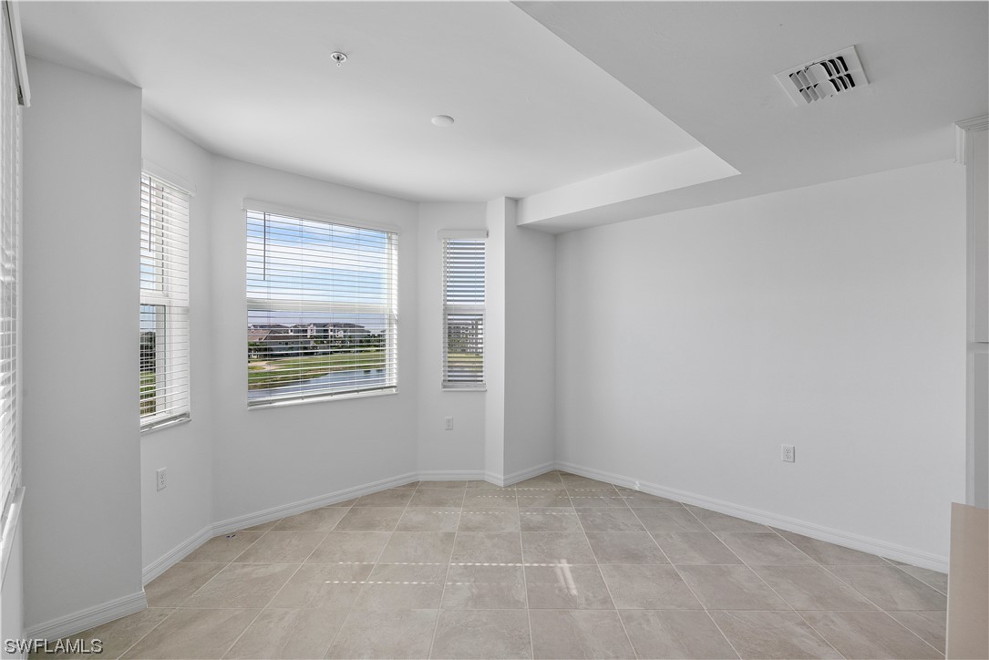 43989 Boardwalk Loop, Unit 2033 Punta Gorda, FL 33982 - Photo 30 of 36 a view of an empty room with wooden floor and a window