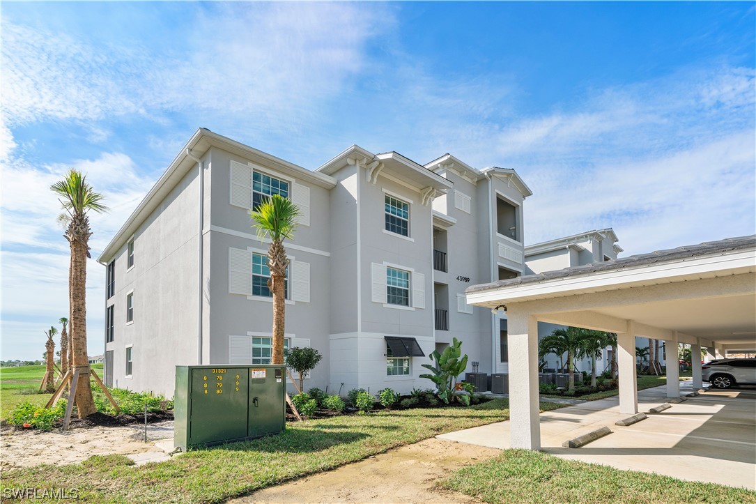 43989 Boardwalk Loop, Unit 2033 Punta Gorda, FL 33982 - Photo 32 of 36 a front view of a building with garden