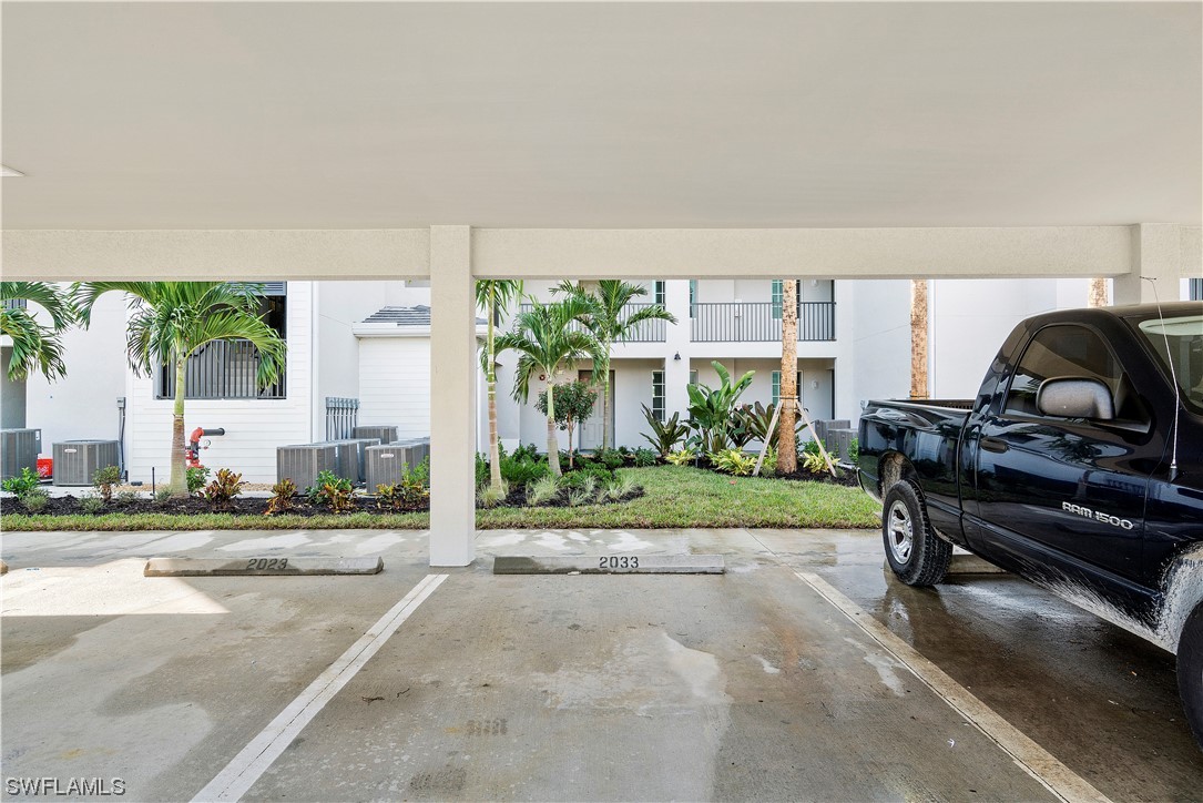 43989 Boardwalk Loop, Unit 2033 Punta Gorda, FL 33982 - Photo 34 of 36 a living room with furniture and a floor to ceiling window