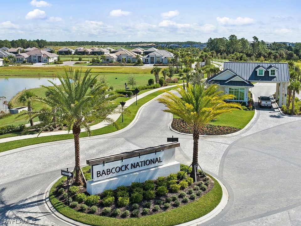 43989 Boardwalk Loop, Unit 2033 Punta Gorda, FL 33982 - Photo 36 of 36 a view of a swimming pool with a table and chairs