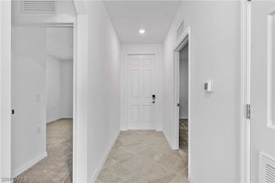 43989 Boardwalk Loop, Unit 2033 Punta Gorda, FL 33982 - Photo 9 of 36 a view of a hallway with wooden shelves