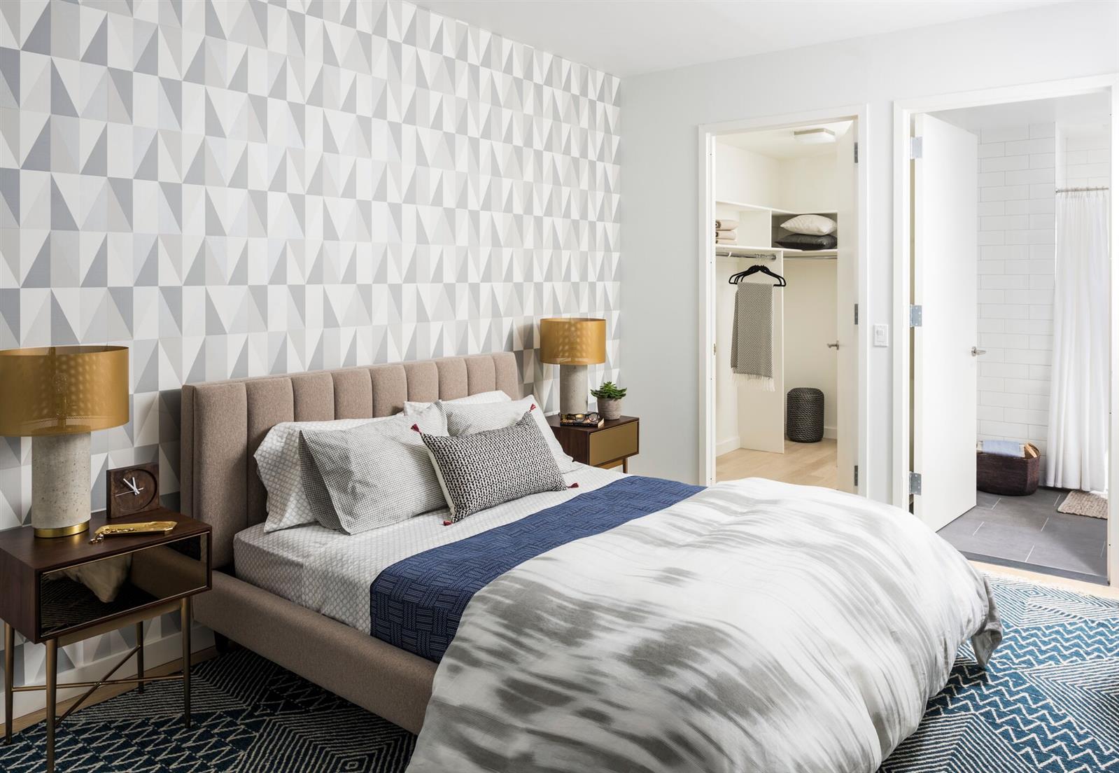 a bedroom with a bed and a lamp with the dresser