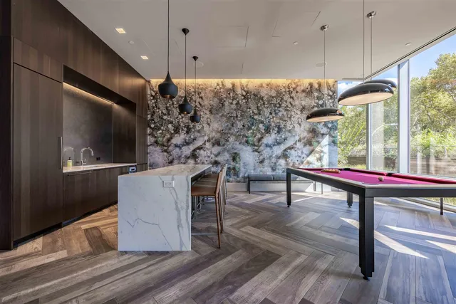 a living room with furniture a flat screen tv and a wooden floor