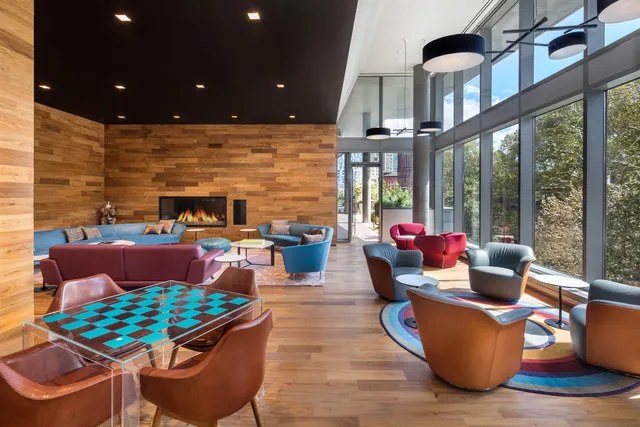 a living room with furniture and a floor to ceiling window