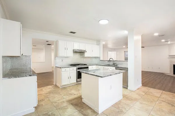 a kitchen with a granite countertop sink and a granite counter tops