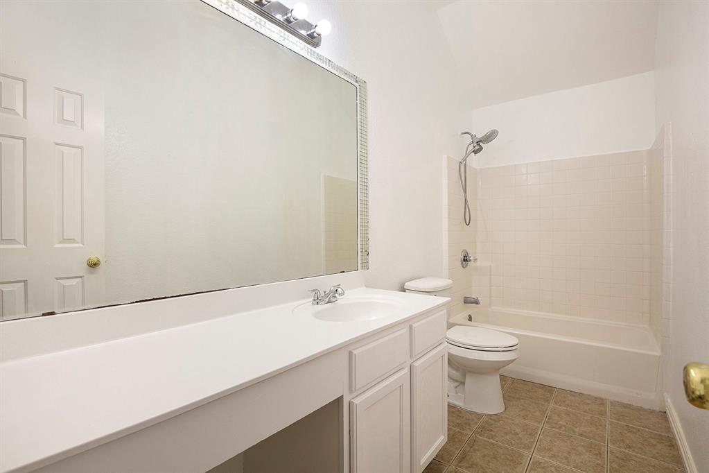 4800 Sleepy Ridge Circle Fort Worth, TX 76133 - Photo 25 of 40 a bathroom with a sink a toilet and shower