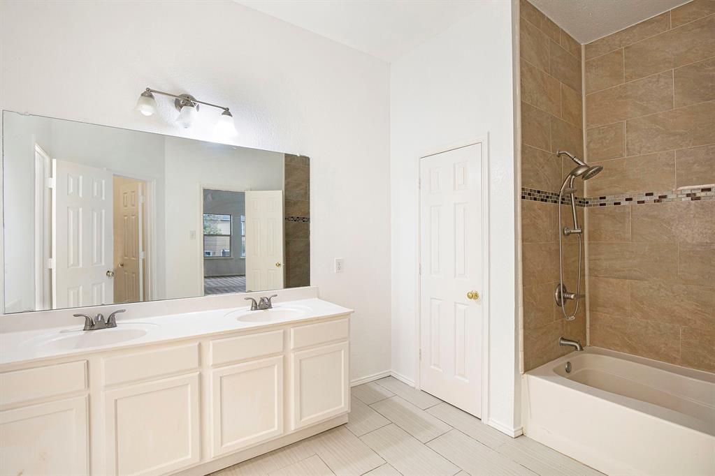 4800 Sleepy Ridge Circle Fort Worth, TX 76133 - Photo 27 of 40 a bathroom with a double vanity sink mirror and shower