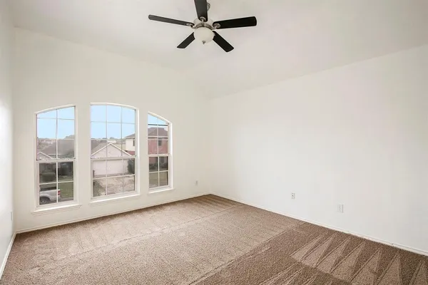 a view of a room with a ceiling fan