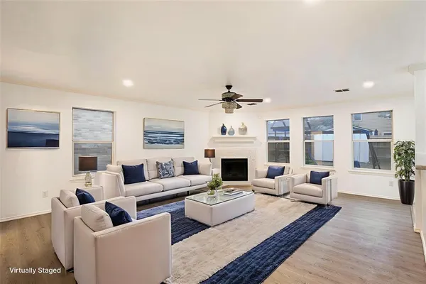 a living room with fireplace furniture and a rug