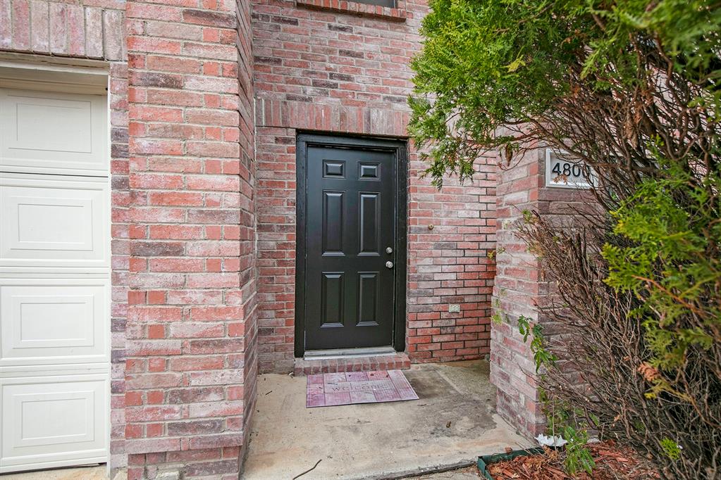 4800 Sleepy Ridge Circle Fort Worth, TX 76133 - Photo 4 of 40 a brick house with a door and a large window