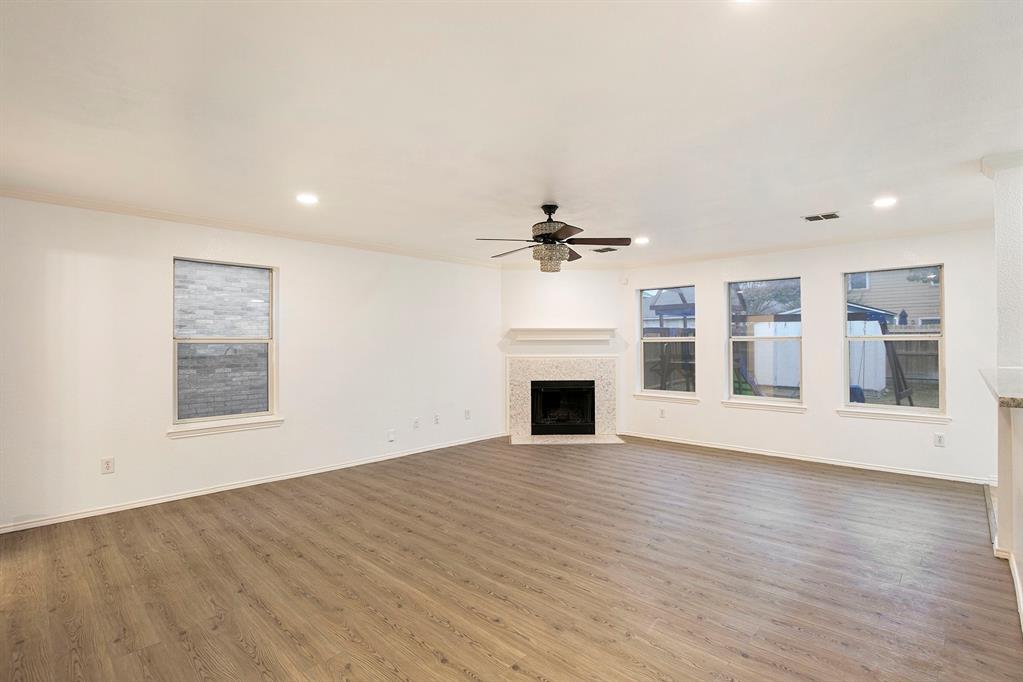 4800 Sleepy Ridge Circle Fort Worth, TX 76133 - Photo 6 of 40 a view of empty room with wooden floor and fireplace