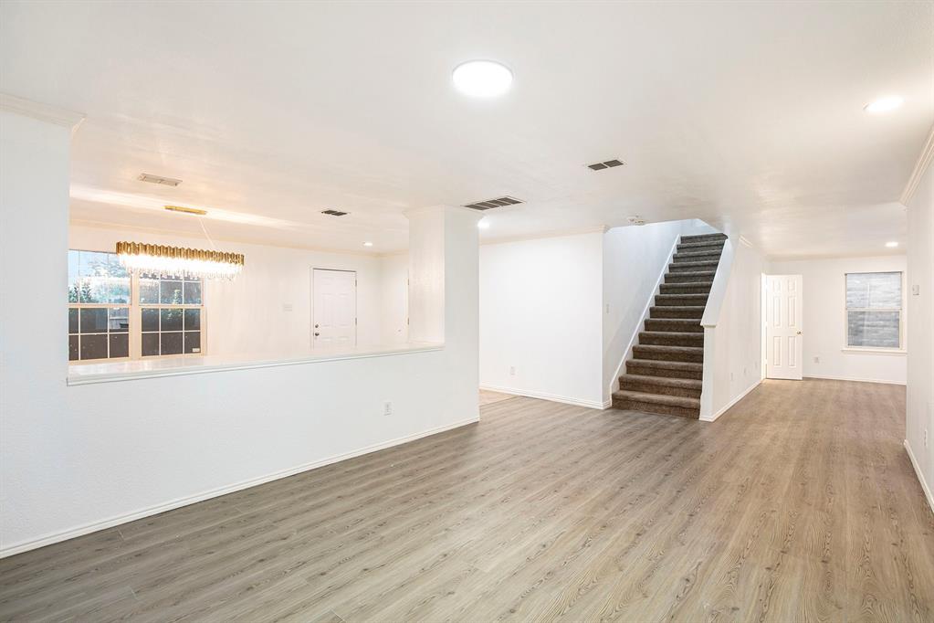 4800 Sleepy Ridge Circle Fort Worth, TX 76133 - Photo 10 of 40 an empty room with wooden floor and windows