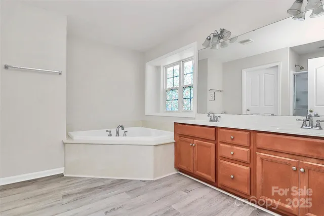 a bath room with sink and mirror