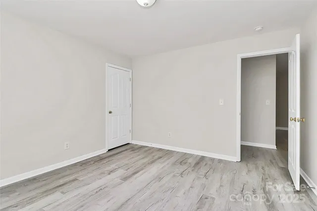 a view of room with wooden floor