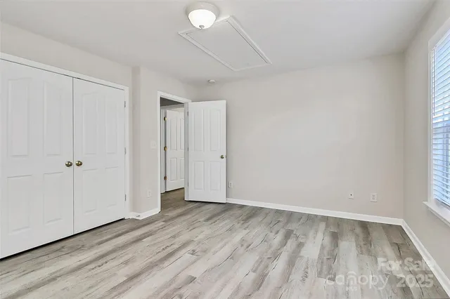 a view of wooden floor and windows in a room