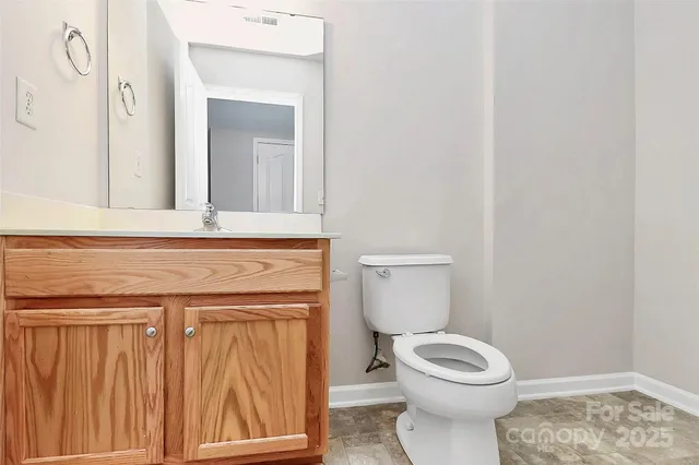 a bathroom with a toilet a sink and a window