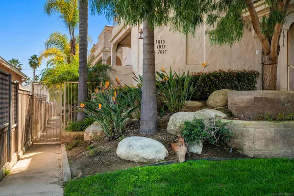 a backyard of a house with lots of green space and fountain