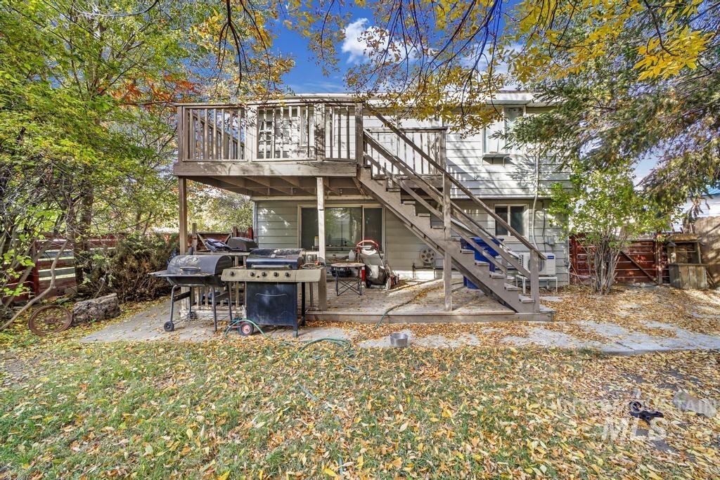 111 2nd Street Rupert, ID 83350 - Photo 7 of 45 Rear facade featuring a two-story wood deck with stairs, a ground-level patio, and sliding glass doors