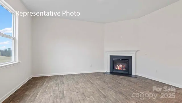 a view of an empty room with a fireplace