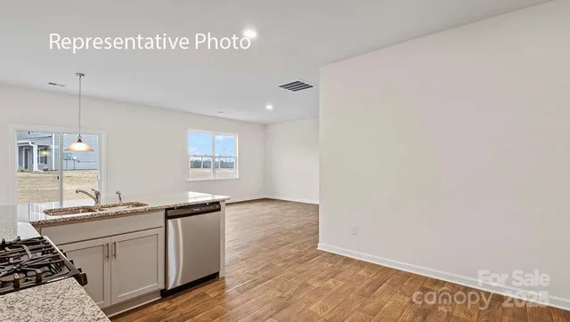 a kitchen with granite countertop a sink and a stove