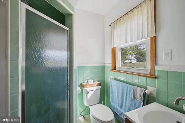 a white toilet sitting next to a bathroom sink
