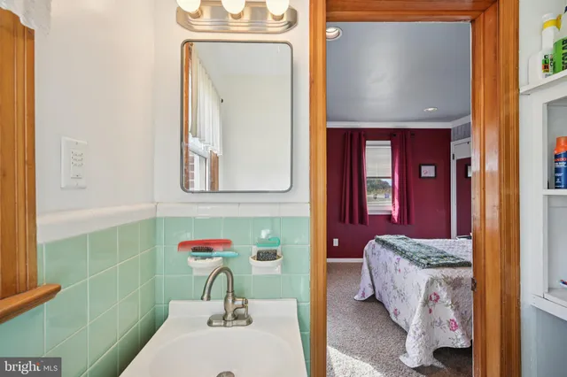 a bathroom with a sink a toilet and mirror