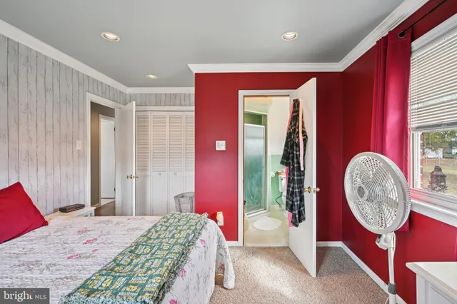 a bedroom with a bed and a mirror