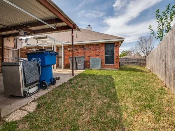 a view of a porch with furniture and a yard