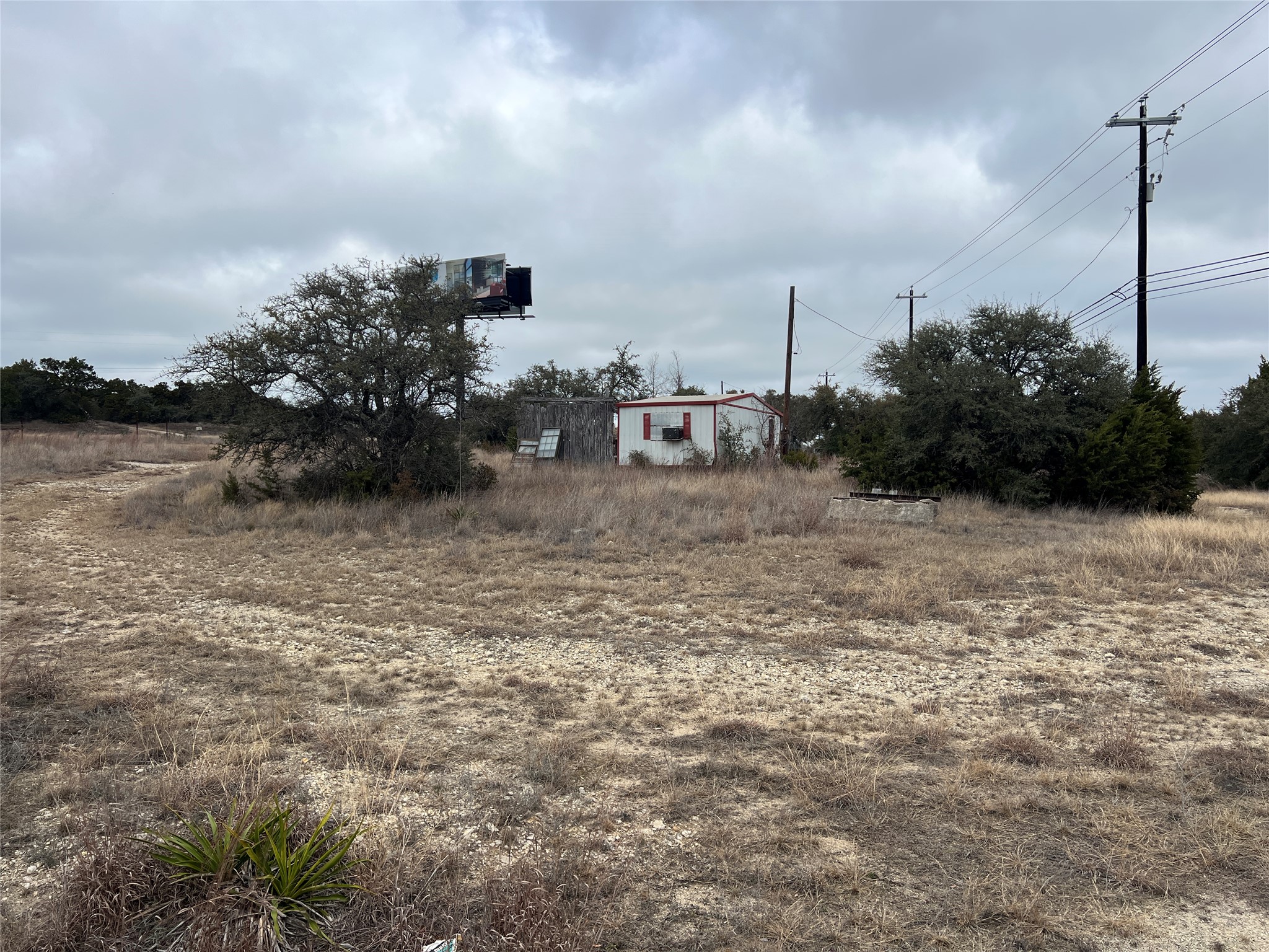 4 Anglin Lane Austin, TX 78737 - Photo 11 of 27 a view of a dry yard with wooden fence