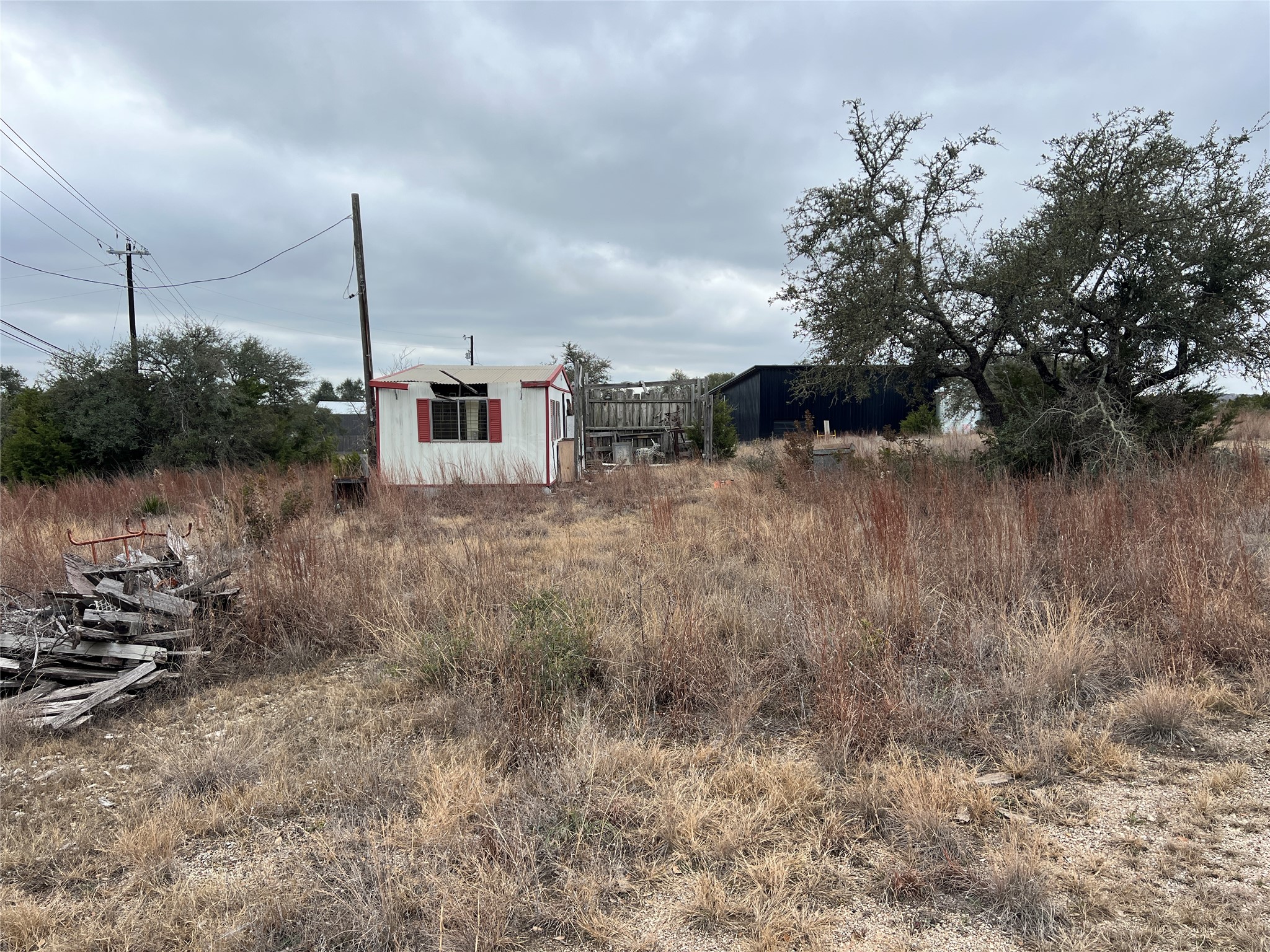 4 Anglin Lane Austin, TX 78737 - Photo 17 of 27 a view of a dry yard with wooden fence